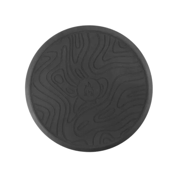 A black round mat with a design on it.