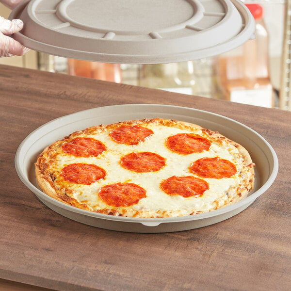 A pizza in a World Centric compostable fiber pizza container base.