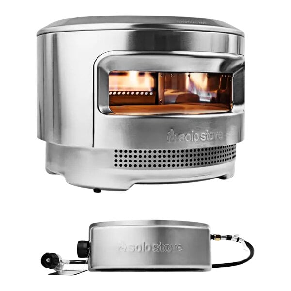 A stainless steel Solo Stove Pi Pizza Oven with a fire inside.