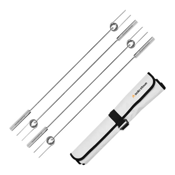 A set of Solo Stove stainless steel roasting sticks in a white case with black straps.