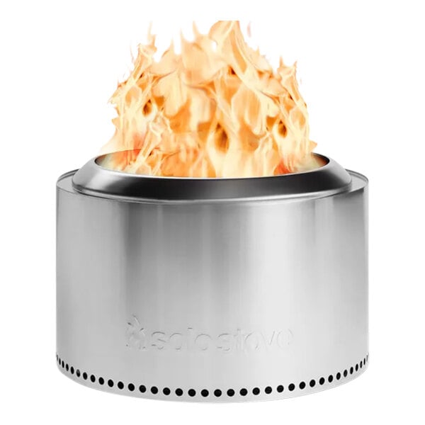 A Solo Stove Yukon 2.0 stainless steel fire pit with flames inside.