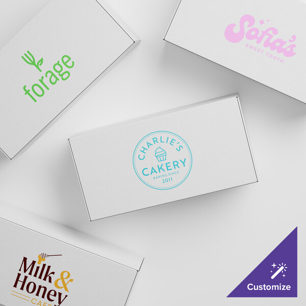 A group of customizable white candy boxes with pink, blue, and green text.