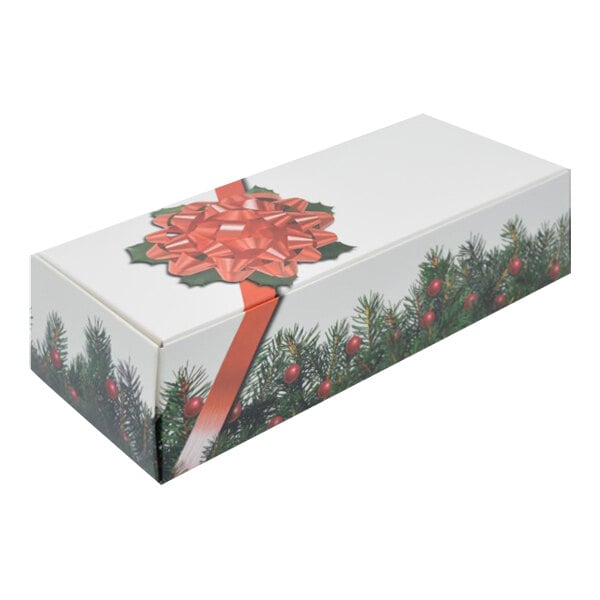 A white box with a red bow and green branches.