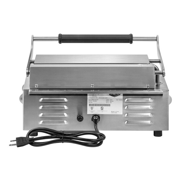 A silver Vollrath cast iron panini grill with a black handle.