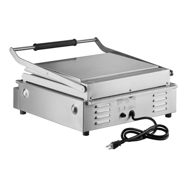 A large stainless steel electric panini grill with smooth plates and a handle, featuring a power cord.