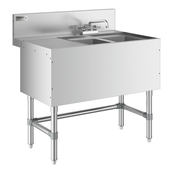 A Regency stainless steel underbar sink with two sinks, a faucet, and a left drainboard.
