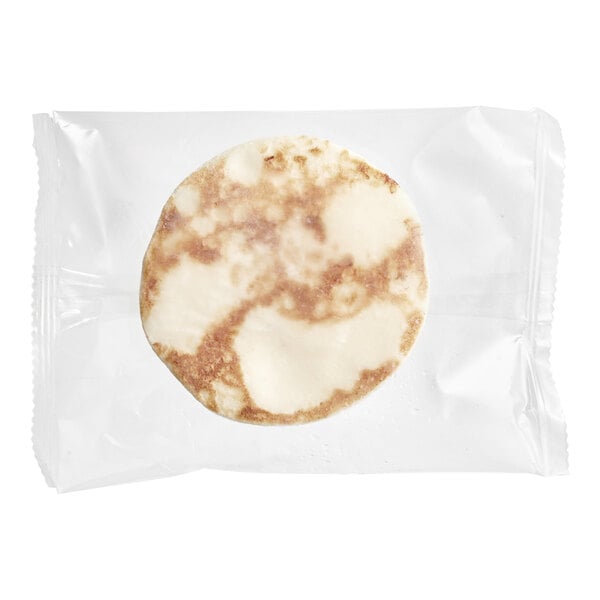 A white and brown Yo Egg Plant-Based Sunny Side Up Egg in a plastic bag.