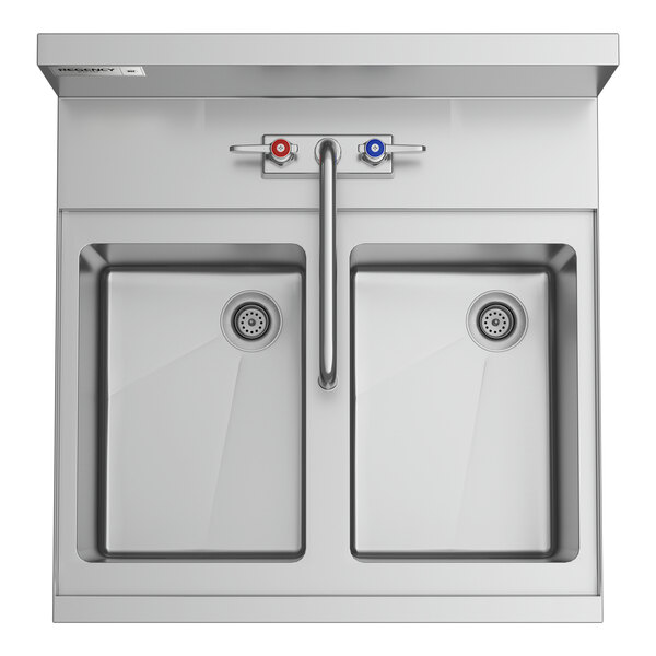 A Regency stainless steel underbar sink with two faucets.