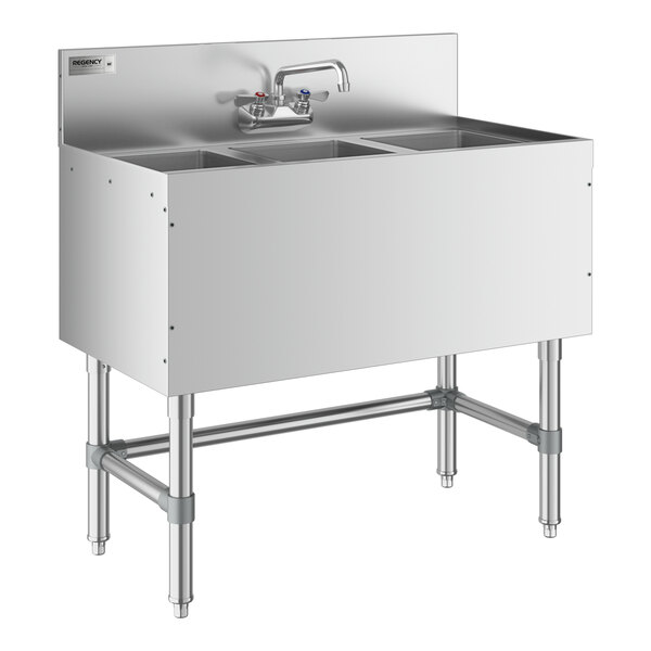 A Regency stainless steel underbar sink with three compartments and a faucet.
