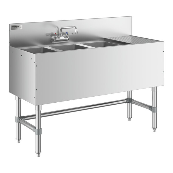 A Regency stainless steel underbar sink with three bowls, a right drainboard, and faucet.