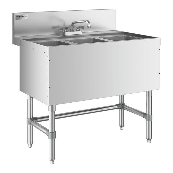 A Regency stainless steel underbar sink with three bowls and a faucet on a counter.