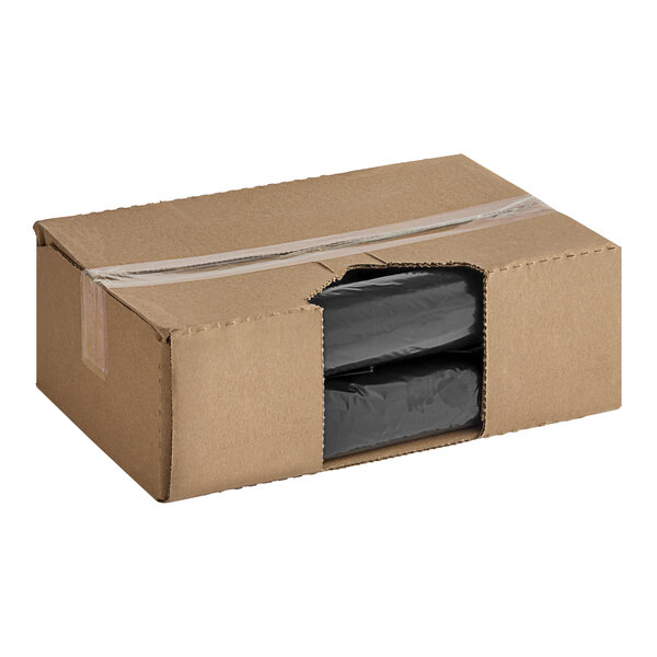A cardboard box with black plastic bags inside.