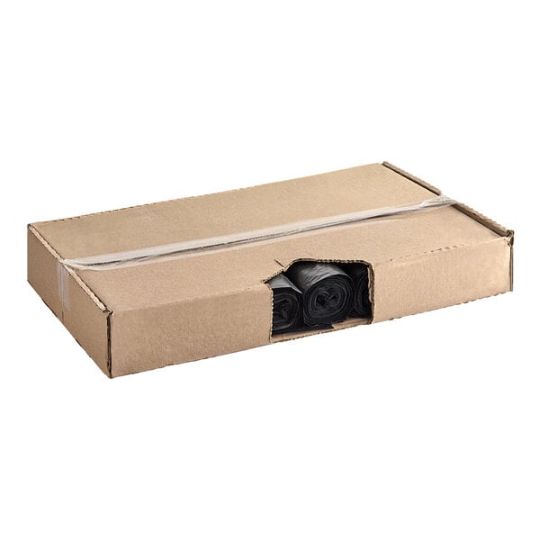 A cardboard box with black plastic bags inside.