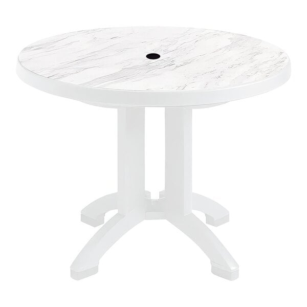 A white table with a round top.