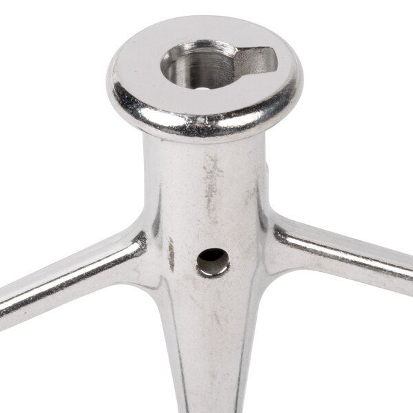 A stainless steel Globe flat beater with a hole in the middle.