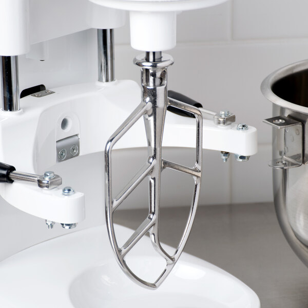A close-up of a silver Globe flat beater for a mixer.