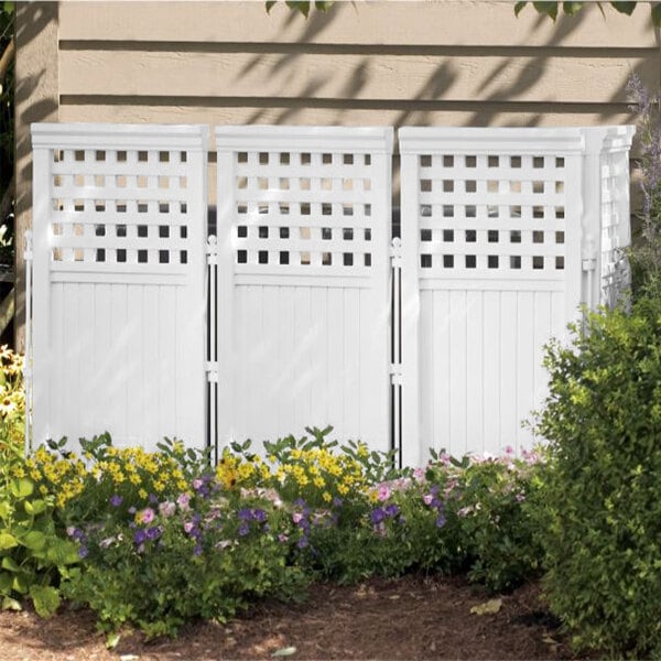 A white Suncast lattice panel fence in a garden.