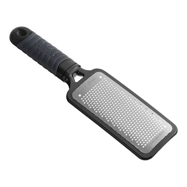 A Microplane black fine grater with a black handle.
