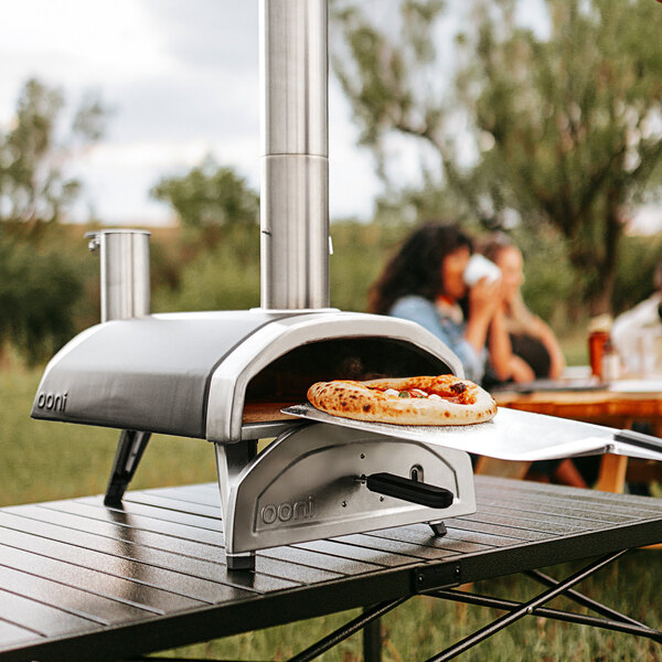 A pizza cooking in an Ooni Fyra wood pellet pizza oven.
