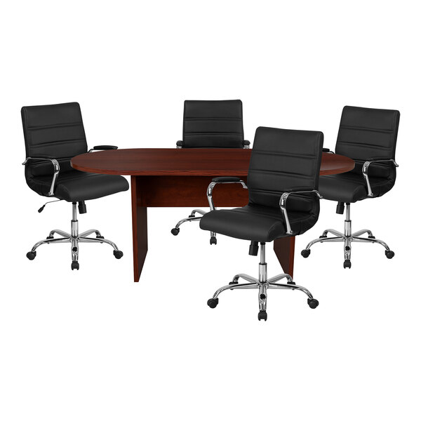 A mahogany oval conference table with four black leather chairs around it.