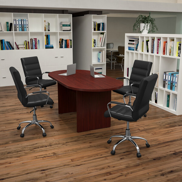 A Lake Mahogany conference table with black LeatherSoft executive chairs around it.