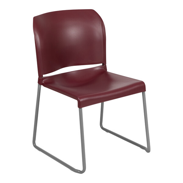 A Flash Furniture burgundy stack chair with metal legs.