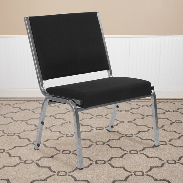 A Flash Furniture Hercules black fabric reception chair with chrome legs in a room.