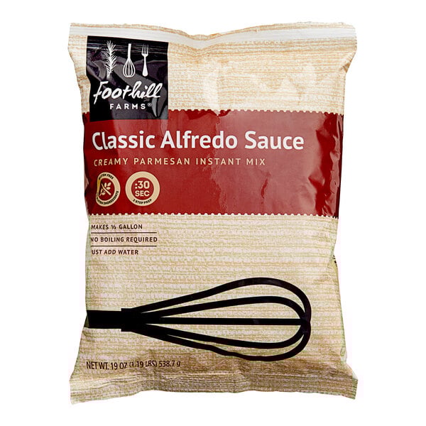 A bag of Foothill Farms Alfredo Sauce mix with a whisk.