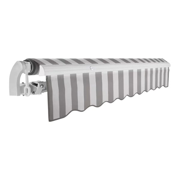 An Awntech California grey and white striped patio awning extended over a wall.