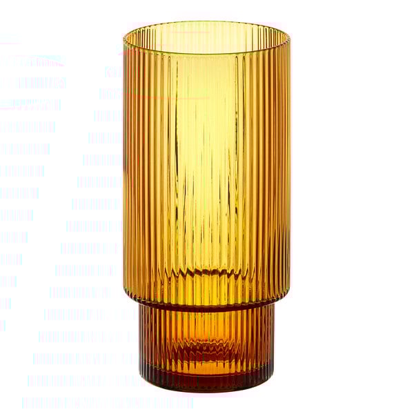 An Acopa Lore ribbed glass tealight holder with a yellow base.