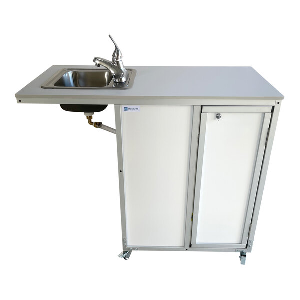A white wheelchair accessible portable sink and cabinet on wheels.