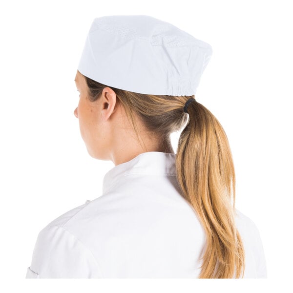 A person wearing a white cap and white clothing, viewed from behind.