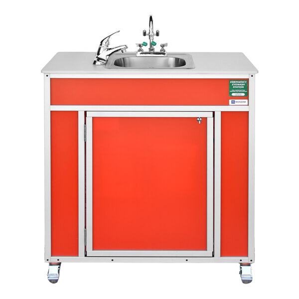 A red portable eye and face washing station with a sink and faucet, mounted on wheels.