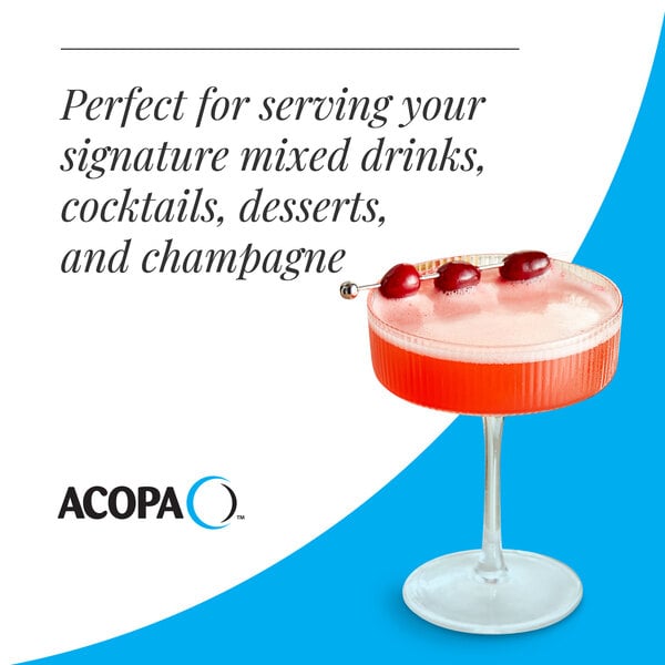 A clear coupe glass with a short stem, filled with a red cocktail and garnished with three cherries on a pick.