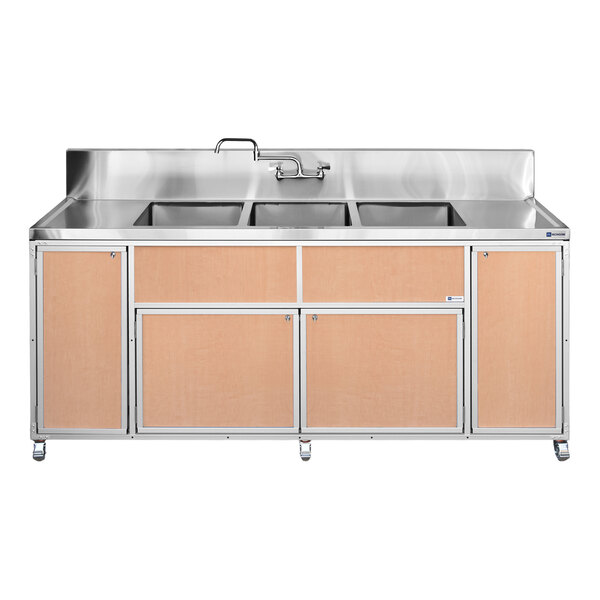 A portable commercial sink unit with three deep basins, two drainboards, and maple-colored paneling.