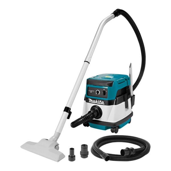 A Makita vacuum cleaner with hose and attachments.