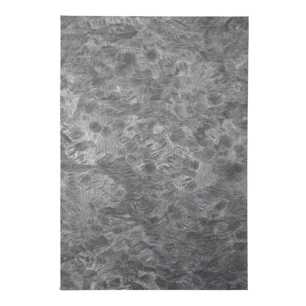 A close-up of a brushed metallic steel surface.