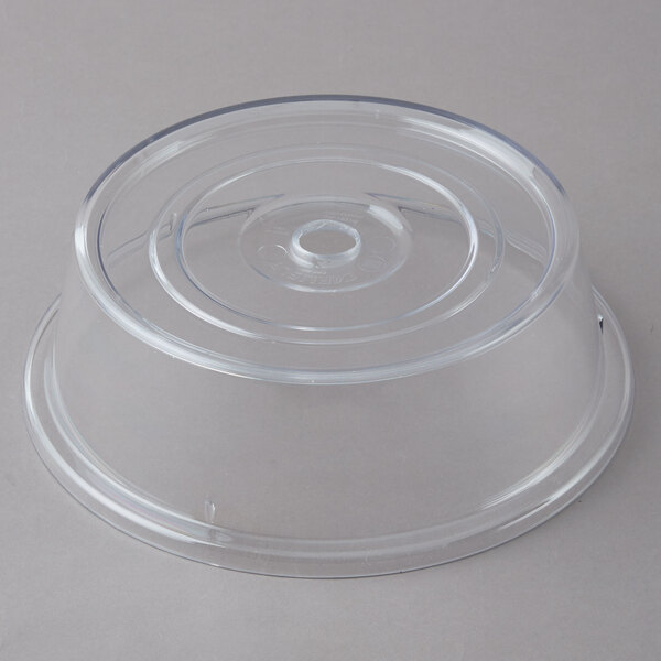 A clear plastic Carlisle plate cover with a circular rim.
