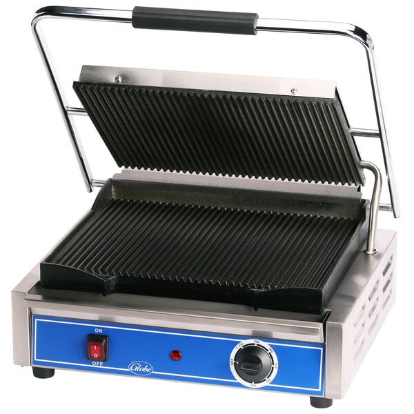 A Globe panini sandwich grill with a blue handle on a counter.