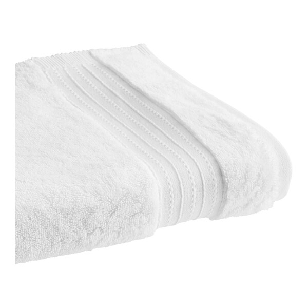 A close-up of a folded white 1888 Mills Pure Terry bath towel.