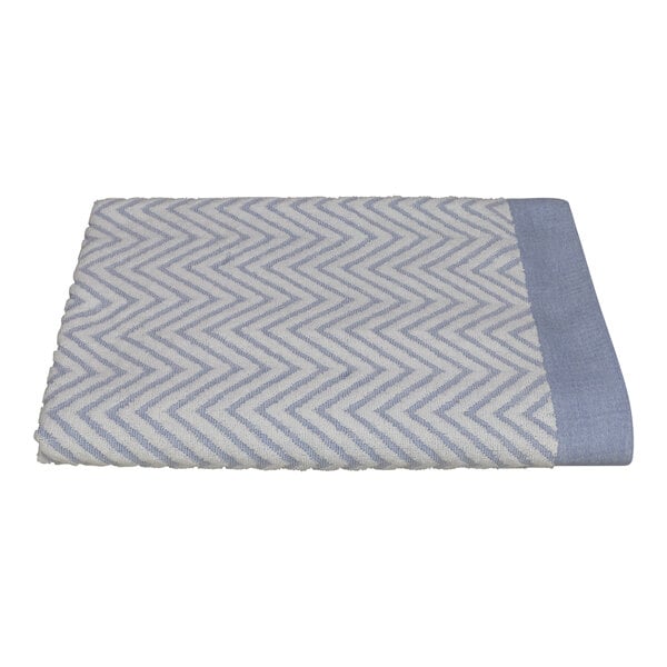 A folded blue and white 1888 Mills Fibertone jacquard pool towel with a zigzag pattern.