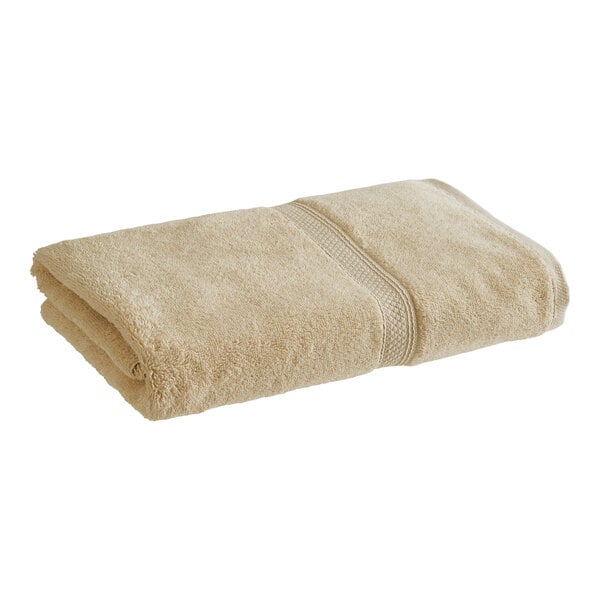 A beige 1888 Mills Magnificence Pima cotton bath sheet folded.