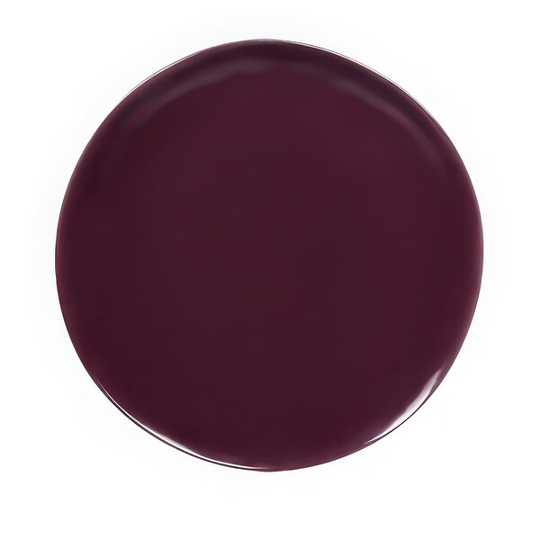 A purple plate with a white reactive glaze on a white background.