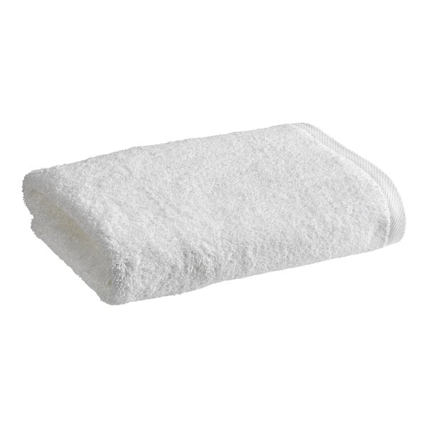 A rolled white 1888 Mills Millennium bath sheet.
