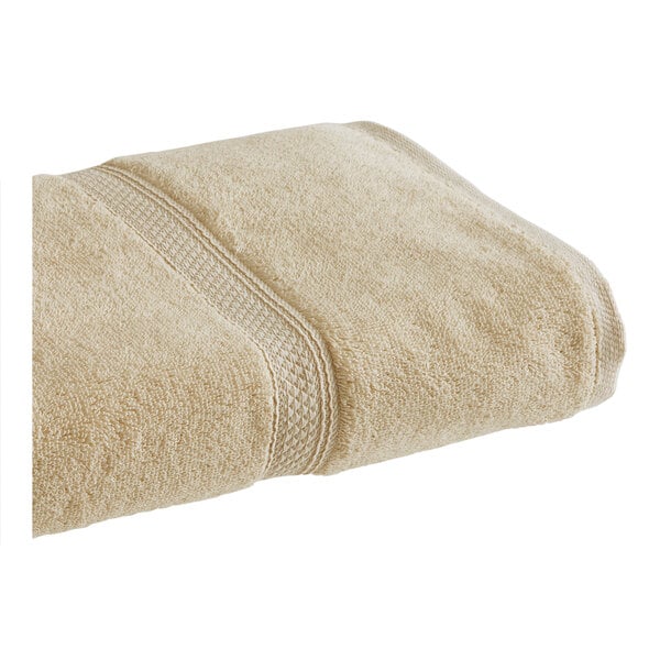 A beige 1888 Mills Magnificence Pima Cotton bath towel.
