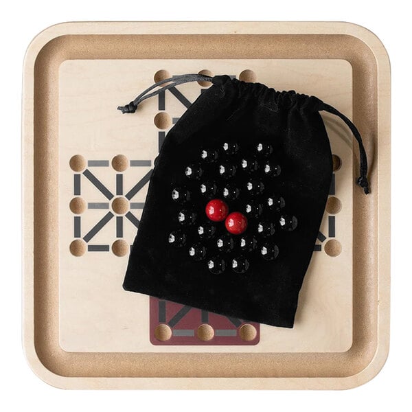 A black Yard Games table top game board with red balls on it.