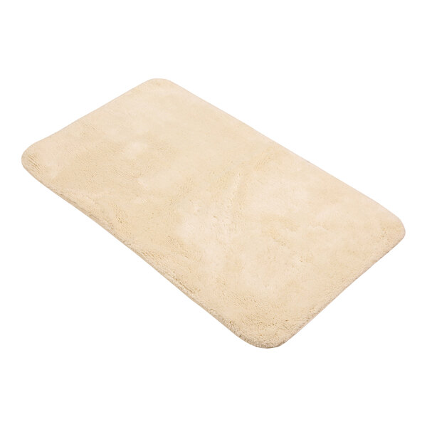 A beige 1888 Mills Magnificence Pima Cotton bath rug.