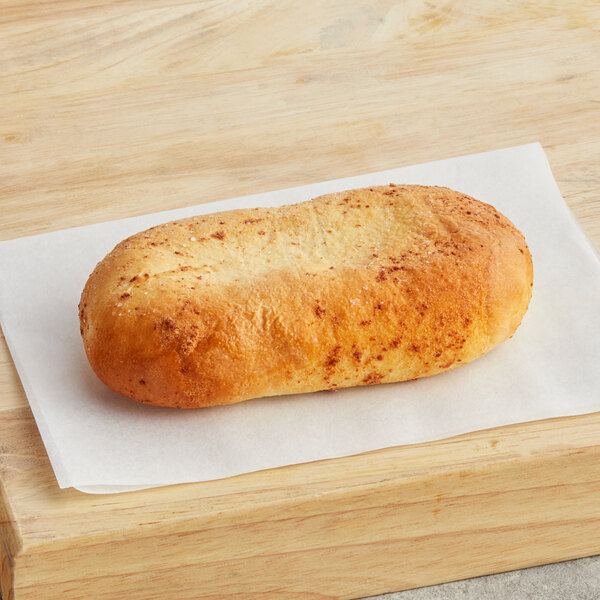 A Grand Prairie 4 cheese calzone on a white paper towel.