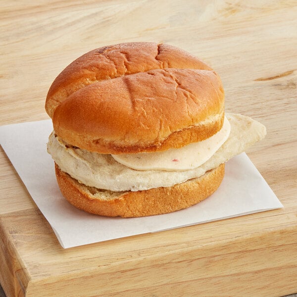 A Grand Prairie Buffalo chicken sandwich on a wooden surface.