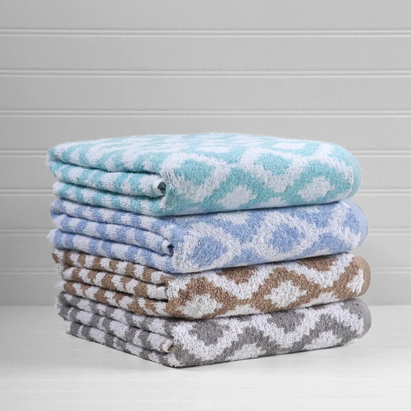 A stack of teal diamond jacquard pool towels.